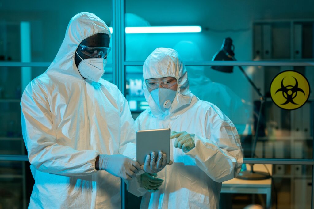 Two workers of scientific laboratory discussing online clinical data